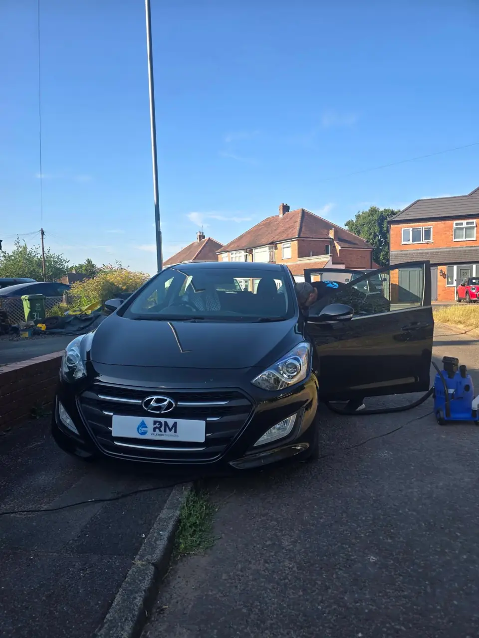 Finished black Hyundai i30 with the door open after its Gold valet