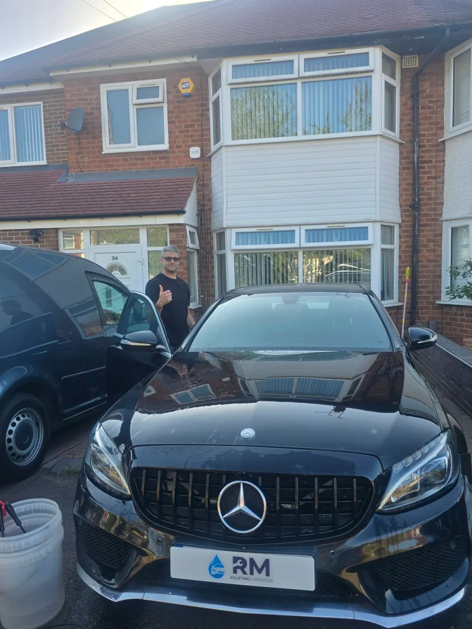 Freshly valeted black Mercedes C220 AMG Line with Riyaz giving a thumbs up
